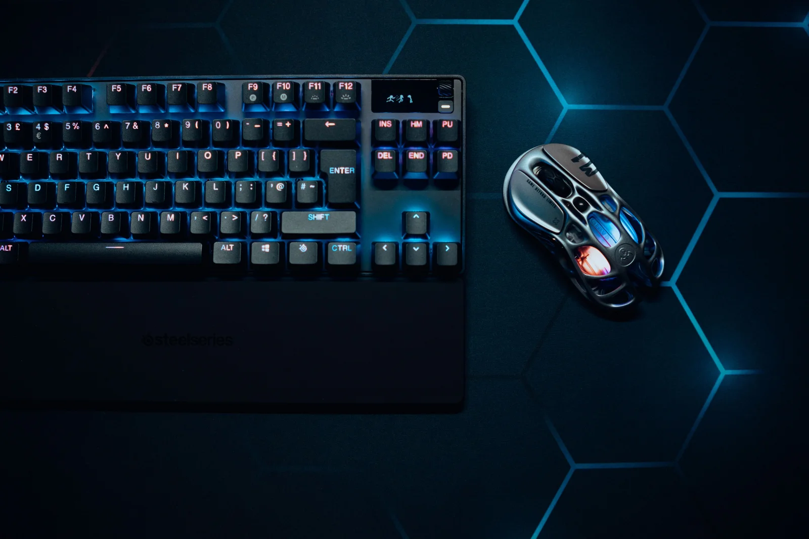 SteelSeries Sensei Pro mouse on a gaming setup with vibrant lighting