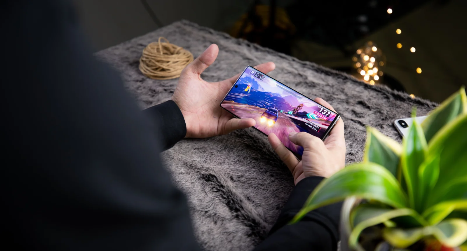 A dramatic depiction of mobile gaming with shadowy figures