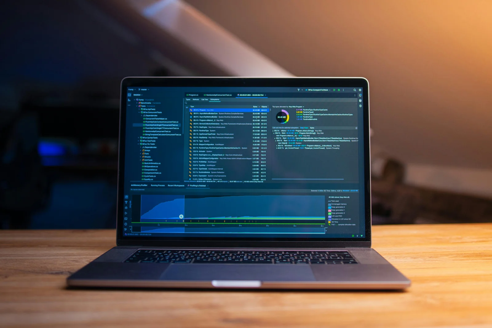 A developer laptop illuminated in a dark room.