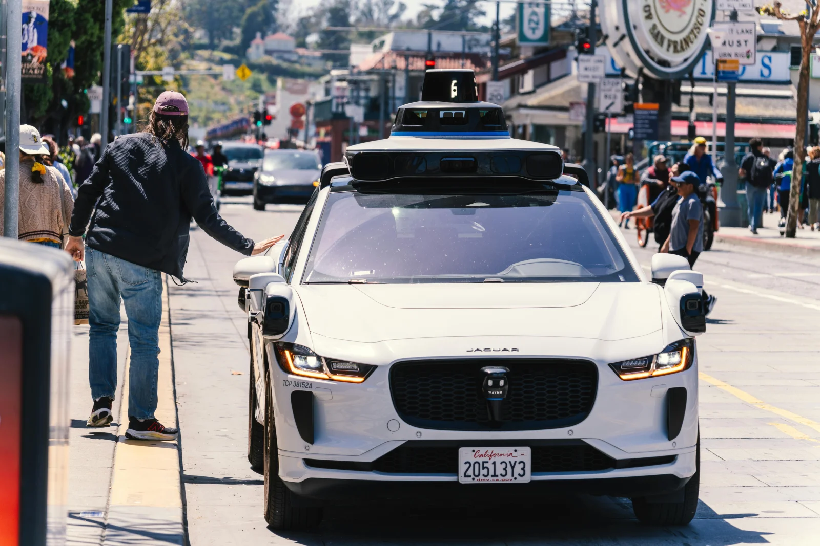 A Waymo autonomous vehicle navigating a city street